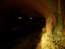 [Railway bridge lit by headlights]