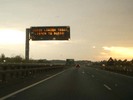 [Road sign: 'Avoid London today. Listen to radio']
