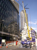 [A crane being lifted onto the old Stock Exchange Tower]